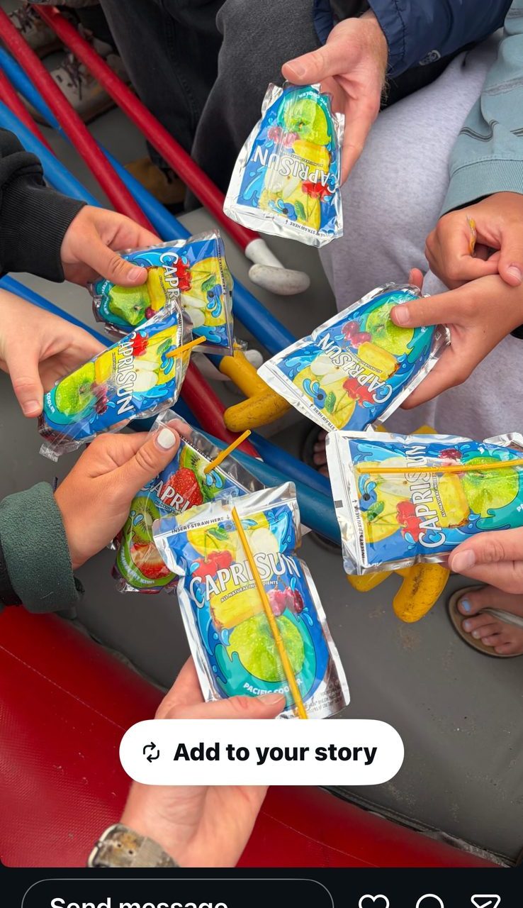 Hands raised together with Capri Suns on the raft — a cheers to Scott