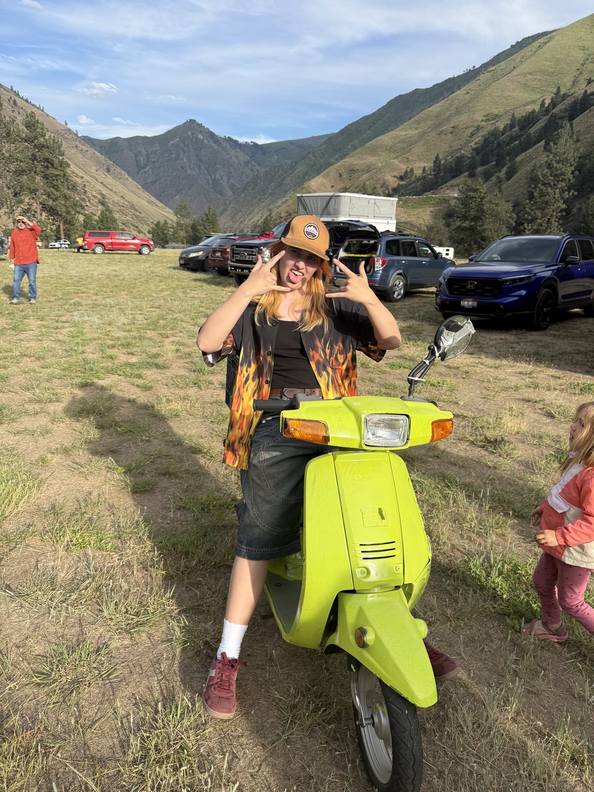 A friend with a green scooter in the meadow by the put-in