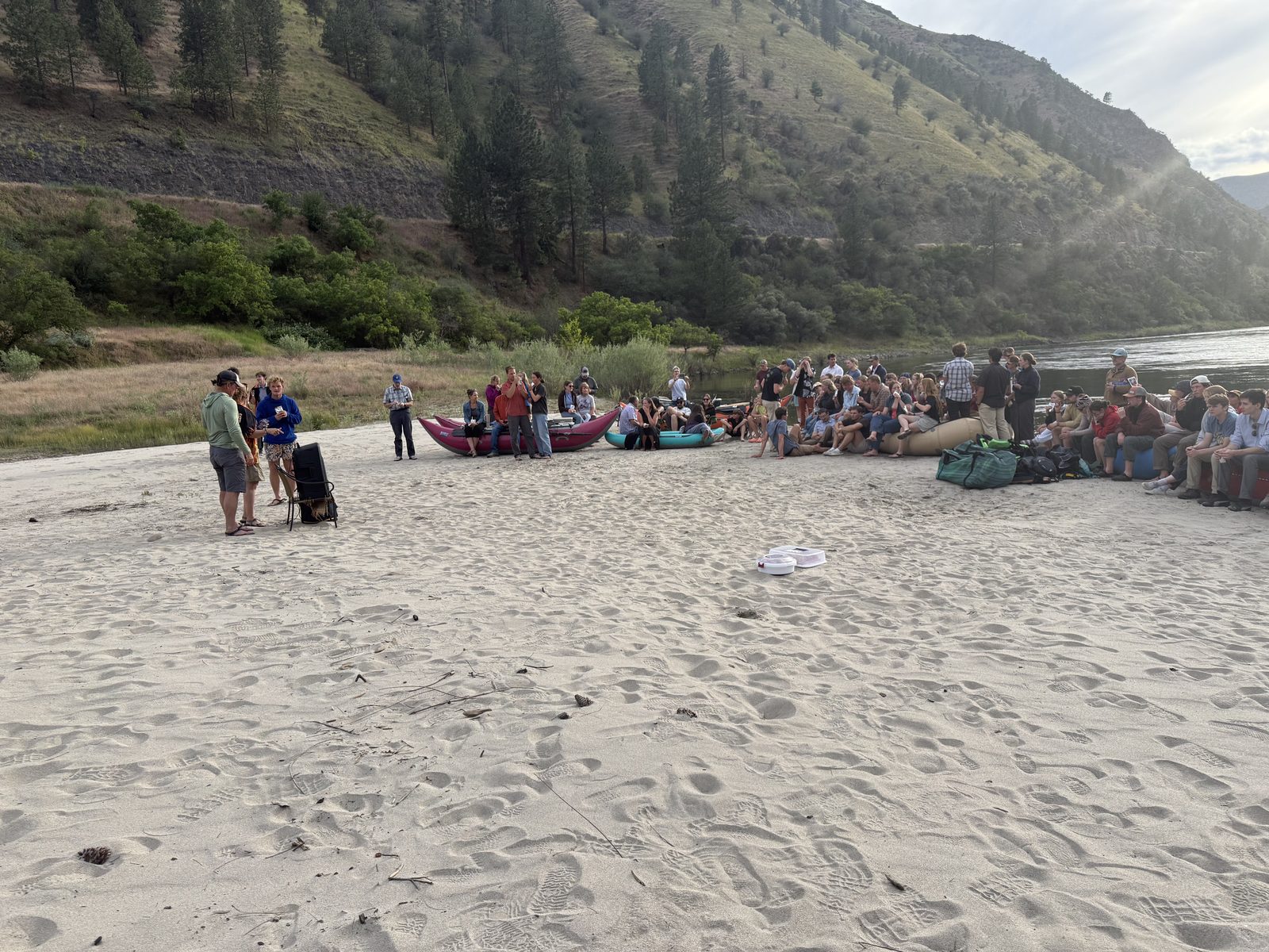 The crowd gathered on the beach by the river