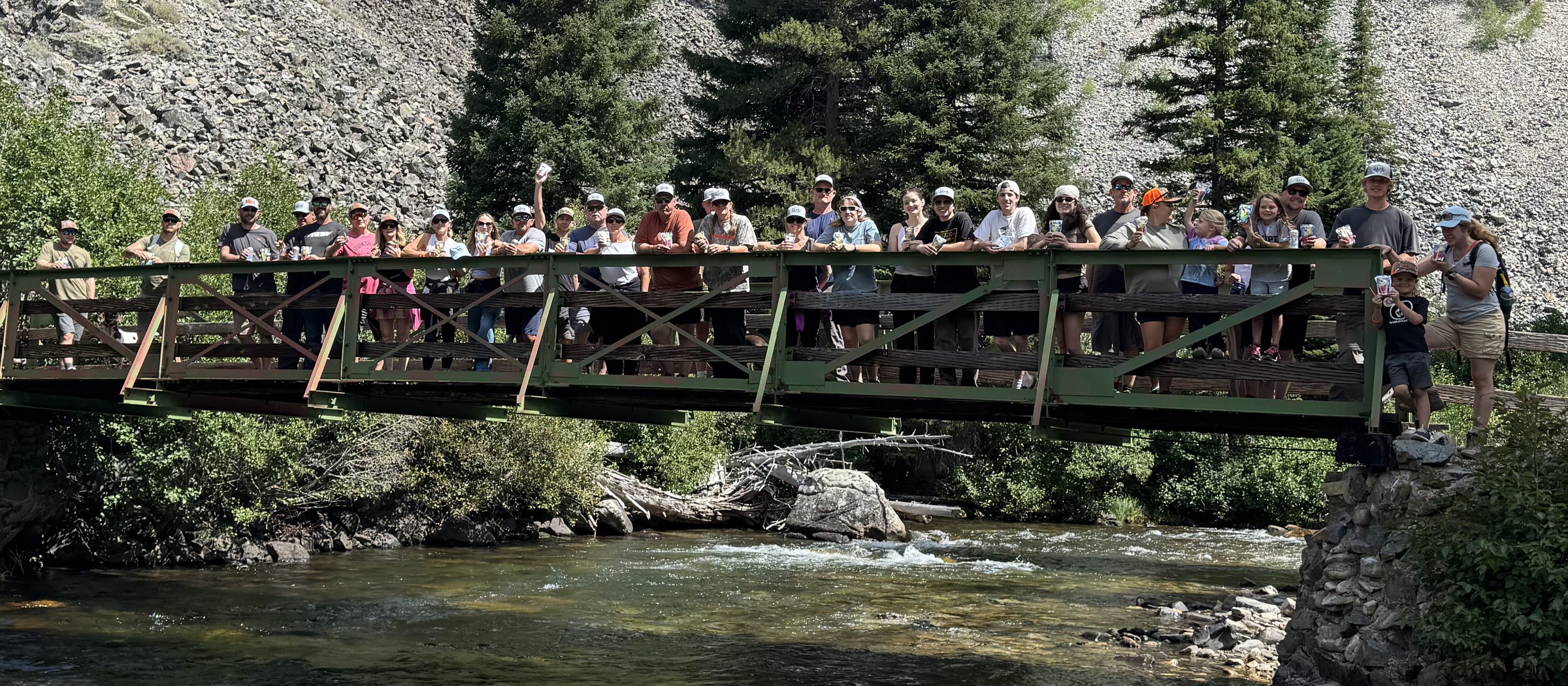 Scott&rsquo;s family and friends lined up along Marsh Creek Bridge, the creek running underneath and the Sawtooths behind them
