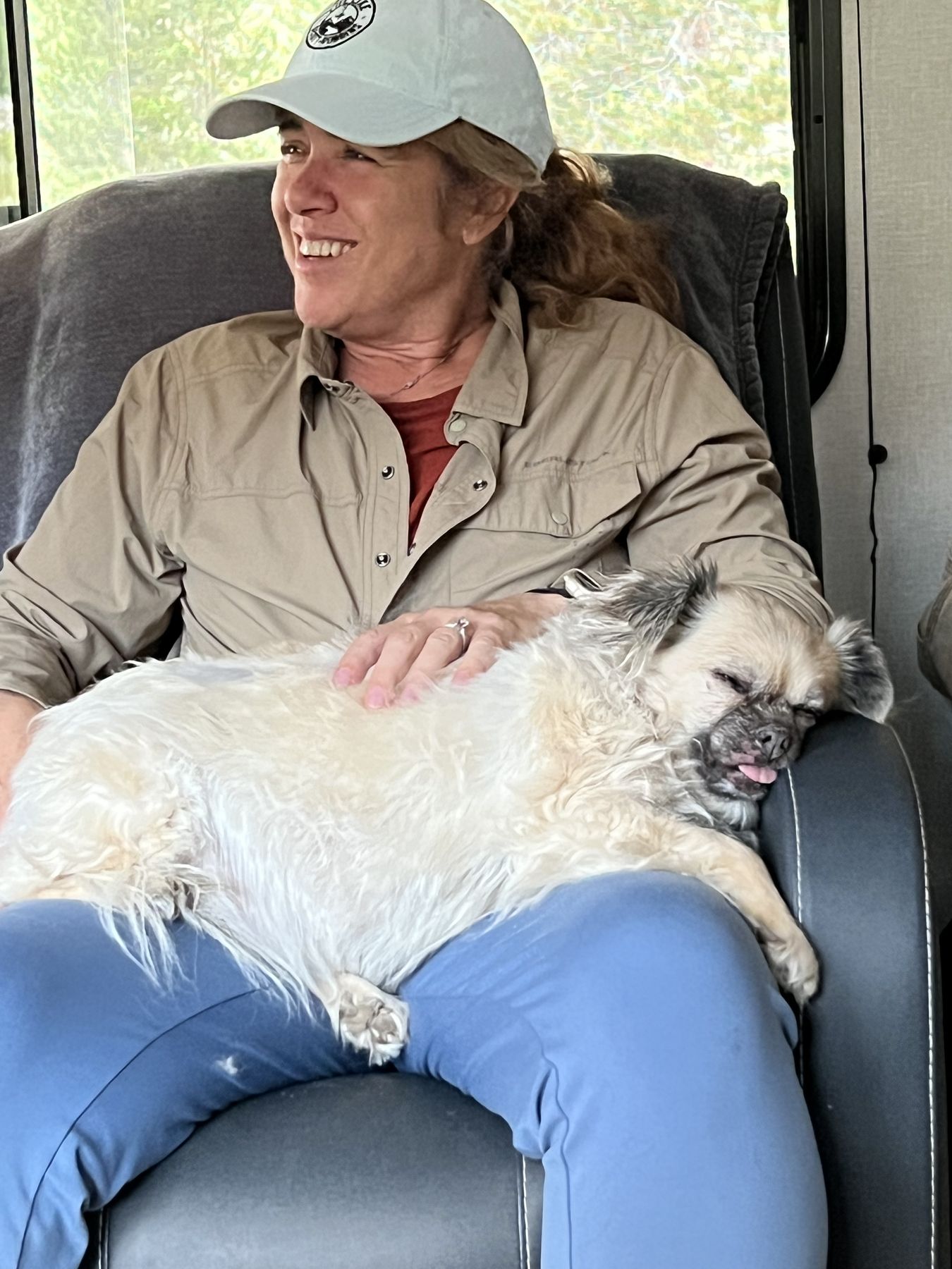 A quiet moment back at camp, a little white dog asleep across her lap