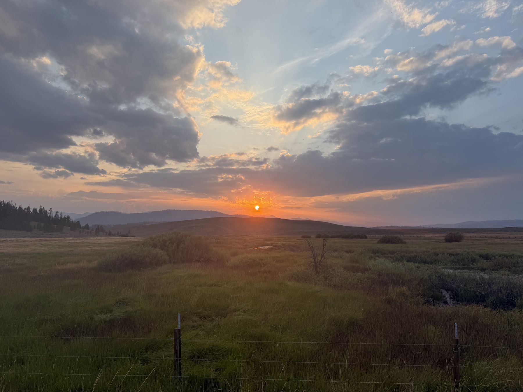 Sunset over the Stanley basin, the sun dropping behind the far ridge