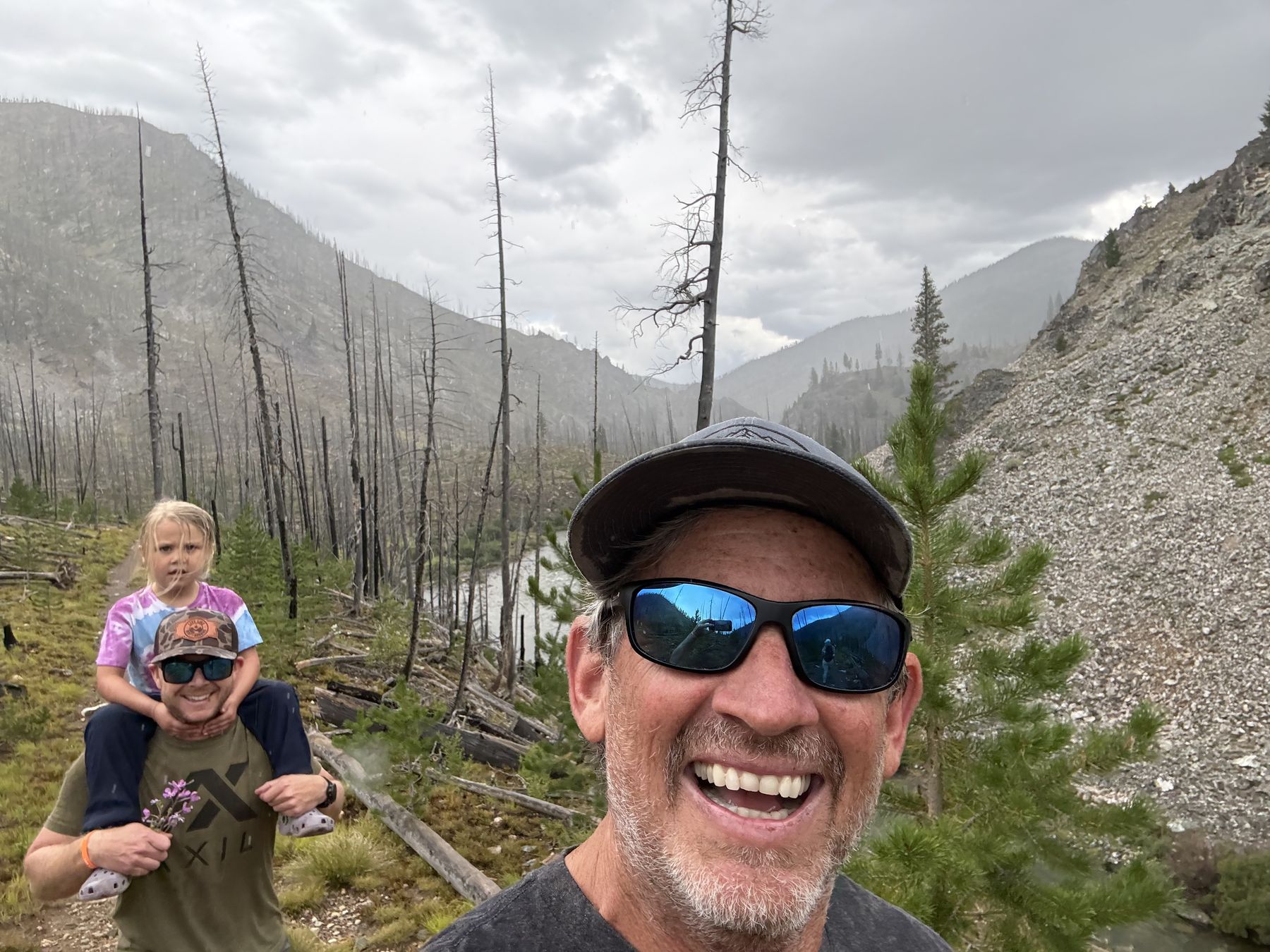 A grinning selfie on the way out, a little girl riding on someone&rsquo;s shoulders behind